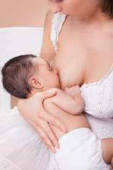 Obraz na płótnie Canvas mother breast feeding her child