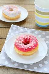pink donut on a white plate