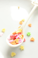 Fototapeta na wymiar heart shaped candy on spoon for background image