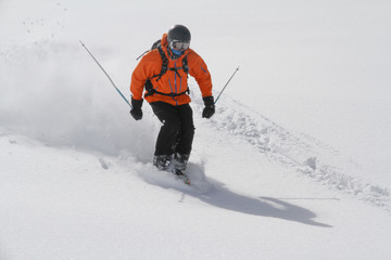 Skier in deep powder, extreme freeride