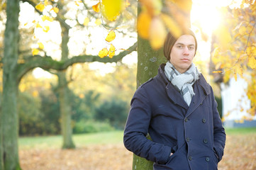 Portrait of a relaxed young man standing alone outside