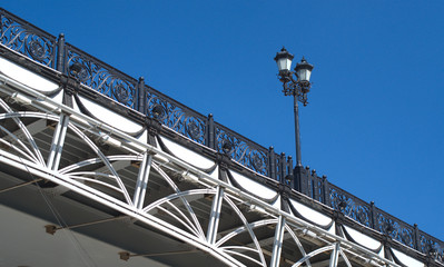 Retro styled arc bridge with decorative fence and lantern