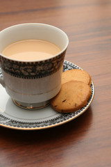 A cup of tea with biscuits