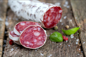 sliced dried salami on rustic wooden table