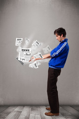Fototapeta premium Young man holding a laptop and reading the explosive news