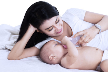 Obraz na płótnie Canvas Young mother is feeding her baby
