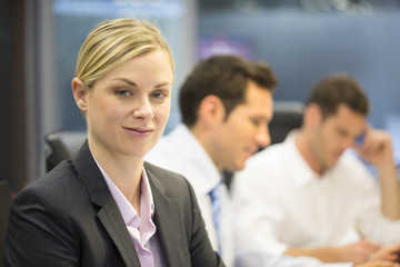 Portrait of smiling businesswoman in office, looking camera