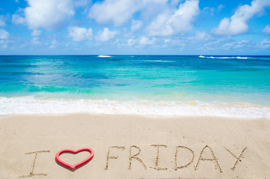 Sign "I love Friday" on the sandy beach