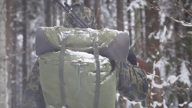Hunter with optical rifle in winter in the woods episode 2
