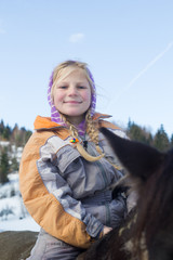Little girl riding horse in winter