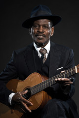 Obraz premium Retro senior afro american blues man. Wearing striped suit with