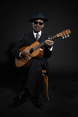 Obraz premium Retro senior afro american blues man. Wearing striped suit with