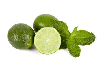 limes with mint leaves on white background