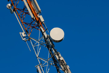 Fototapeta na wymiar Communications tower with antennas on blue sky