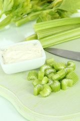 Fresh green celery on cutting board close-up