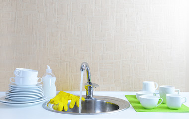 Dishes drying near  metal sink