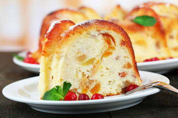 Tasty homemade cake with berries, on wooden table