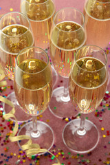 Glasses with champagne on shiny background