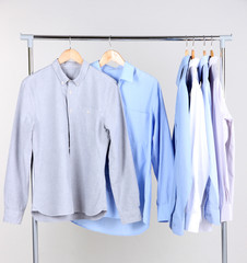 Office male clothes on hangers, on gray background