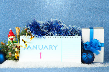 Calendar, New Year decor and fir tree on blue background