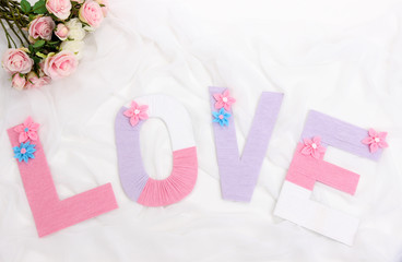Word Love created with brightly colored knitting yard