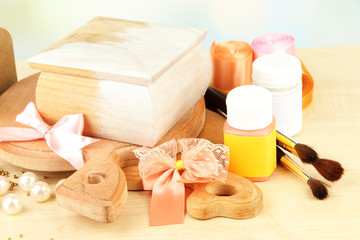 Handmade wooden box and art materials for decor, on table