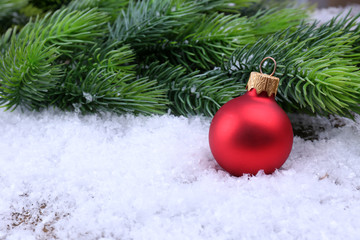 Naklejka na ściany i meble Christmas ball and fir tree on light background