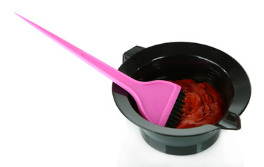 Bowl with hair dye and brush for hair coloring, isolated