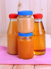 Jars  of various baby food, on wooden background