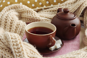 Cup and teapot with scarf close up