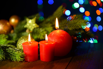 Composition with burning candles, fir tree and Christmas