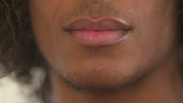 Black teenager showing off tongue piercing