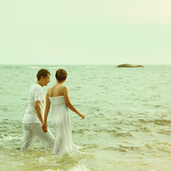 Instagram colorized vintage couple on beach portrait