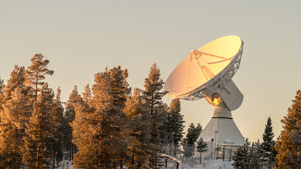Radio telescope in Arctic winter forest