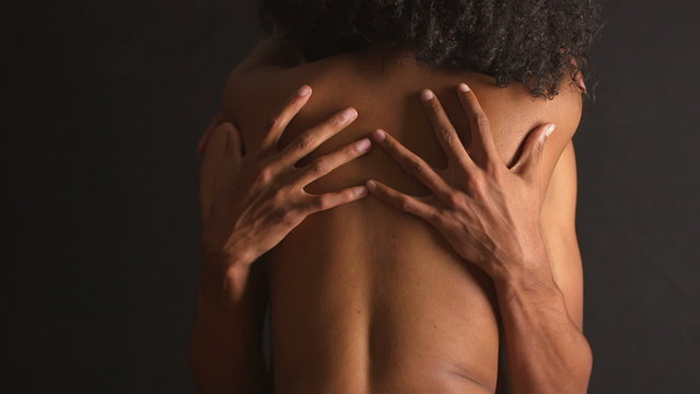 Black woman stroking man's back