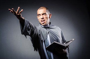 Young priest isolated on the white