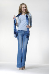 Full length casual fashion woman in jeans with scarf posing