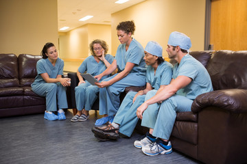 Medical Team Using Digital Tablet In Hospital's Waiting Room