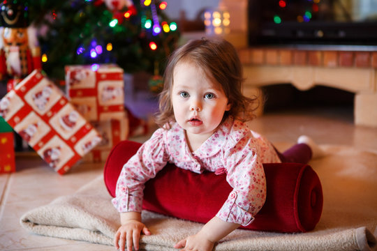 Little girl being happy about christmas tree and lights