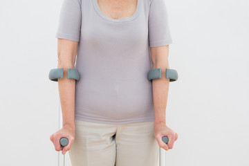 Close-up mid section of a woman with crutches