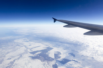 Fototapeta na wymiar Flying above mountains: snow below