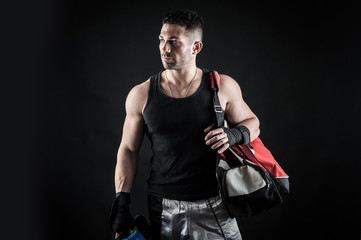 Fototapeta premium Sportsman kick boxer portrait after training against black backg