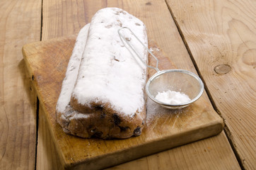 homemade christmas stollen on a wooden board