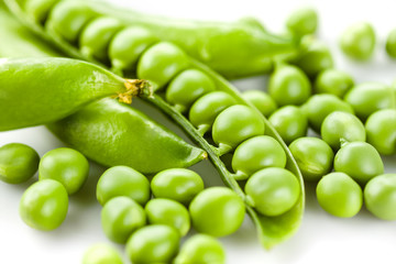 Pods of green peas on white background