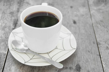 Cup of coffee on wooden table.