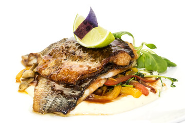 baked fish with vegetables and mushrooms in a restaurant