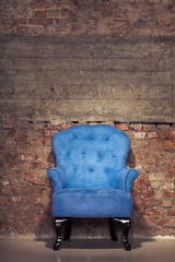 An antique blue velvet chair