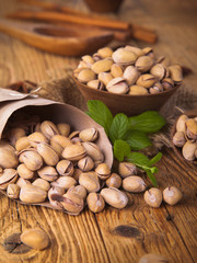 Pistachio nuts, close up on wooden table 