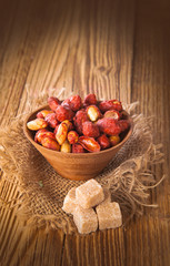 closeup of honey roasted peanuts on wooden table 