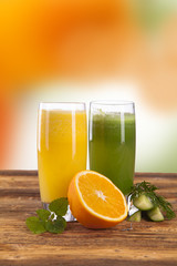 Composition with glass of orange and cucumber juice 